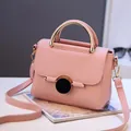 Pink lychee grain leather crossbody bag with golden metal handle and black buckle - Pink