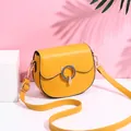 Fashionable bright yellow saddle crossbody bag with golden metal buckle and wide strap - Yellow