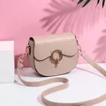 Fashionable nude PU leather saddle bag with golden cat ear buckle and adjustable strap - Khaki