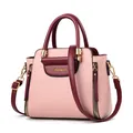 Three-quarter view of a pink and burgundy wing handbag with gold-tone hardware - Burgundy And Pink
