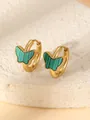 Macro shot of gold butterfly earrings with green striped patterns and beaded edges - Green