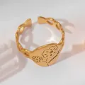 Detailed macro view of 18k gold plated stainless steel ring with floral engravings - Round Flower Style