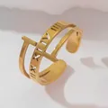 Close-up of 18k gold-plated open ring featuring Roman numerals and T-shaped hollow design - Roman Numeral Letter Style