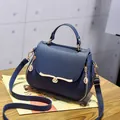Modern dark blue pebbled leather handbag with wavy gold buckle and adjustable strap - Heart Style / Blue