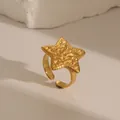 Detail view of gold stainless steel star ring with lava texture on white stone base - Pentagram Shape Lava Texture (W683 Style 3)