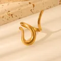 Detailed view of gold wavy textured stainless steel ring on abstract stone props - Abstract Wavy Serpentine Design (W807 Style 2)