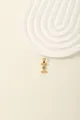 Detailed macro of gold letter I pendant with inlaid blue and white crystals on beige base - Letter I