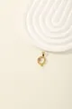 Detail of gold letter Q pendant with blue zircon stones and brushed metal texture - Letter Q