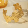 Detailed close-up of golden floral cuff bracelet with intricate petal textures - 3D Camellia Style (W1830-1)