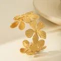 Close-up of golden hammered flower cuff bracelet with intricate petal textures - Four Intertwined Flowers Style (W1832-1)