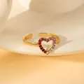 Macro shot of gold adjustable ring featuring a heart-shaped gradient zircon setting - Gradient Colorful Hollow Heart Open Ring (W1490-4)