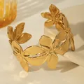 Detail view of the golden floral cuff bracelet with textured petals and open adjustable design - Densely Packed Flowers Style (W1830-3)