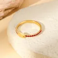 Detail of gold-plated copper ring with red cubic zirconia stones and a geometric link - Red Zirconia Row Setting Geometric Open Ring (W1492-3)