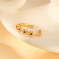 Detail of gold floral open ring featuring tiny red crystals in a delicate vintage style - Red Flower Inlaid Open Ring (W1493-1)