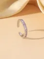 Detail of elegant silver ring with pink zircon inlay on a soft beige silk background - Silver Pink Zirconia Ear Cuff (W1774C)