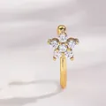 Macro view of a gold star-shaped faux nose ring with sparkling cubic zirconia inlay - Five-petal Flower Style
