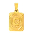Macro shot of gold-plated rectangular pendant with embossed letter G and sunray texture - Letter G