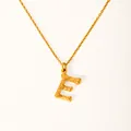 Macro shot of 18k gold plated letter E pendant with detailed bamboo texture and chain - Letter E