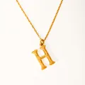 Macro detail of gold-plated H-letter pendant featuring unique bamboo-style carved textures - Letter H
