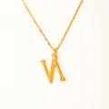 Macro detail of 18k gold plated letter V pendant with unique hammered metal texture - Letter N