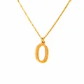 Detailed macro view of 18k gold plated letter O pendant with textured hammer finish surface - Letter O