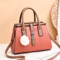 Pink orange leather handbag with V-shaped stitching and brown handles shown in a lifestyle set - Pink