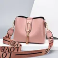 Chic lotus pink handbag with golden tassel detail and wide LOVE printed strap - Pink