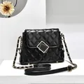 Elegant black quilted chain bag with gold geometric lock and leather strap detail - Black