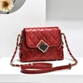 Chic dark red quilted chain shoulder bag with elegant gold square buckle on white podium - Burgundy