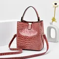 Pinkish purple crocodile pattern bucket bag with shiny gold hardware and shoulder strap - Pink