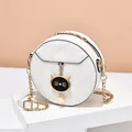 Chic white round quilted crossbody bag with cat charm and gold chain strap for women - White