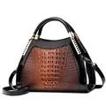 Classic brown crocodile texture handbag with black patent leather accents and gold hardware - Earthy Yellow