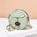 Quilted mint green round crossbody bag with metal zipper and cat charm decoration - Green