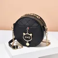 Classic black round quilted crossbody bag with golden chain and cute cat charm decoration - Black