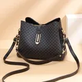 Black leather bucket bag with blue geometric pattern and gold metal clasp detail - Black