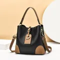 Retro contrast bucket bag in black litchi leather with brown straps and golden D-buckle - Black