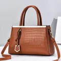 Brown crocodile embossed faux leather handbag with gold hardware and top handles - Brown