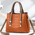 Orange-brown crocodile embossed tote bag with double handles and golden hardware - Earthy Yellow