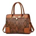 Elegant brown snakeskin embossed handbag with golden lock pendant and dual handles - Earthy Yellow
