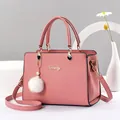 Pink lychee textured handbag with gold hardware, pompom charm and detachable strap - Dusty Pink
