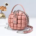 Detailaufnahme der Stepptextur und des Doppelreißverschlusses der runden rosa Tasche - Rosa