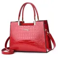 Red shiny crocodile embossed leather handbag with top handles and shoulder strap - Red