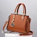 Brown faux leather handbag with geometric triangle pattern and gold-tone hardware - Earthy Yellow