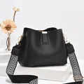 Black pebbled leather bucket bag with a stylish black and white chevron wide strap - Black