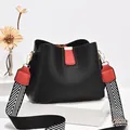 Chic black and red bucket bag with wide geometric patterned shoulder strap - Black and Red