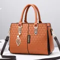 Brown faux leather handbag with geometric embossing and golden leaf pendant detail - Khaki/Earth Yellow