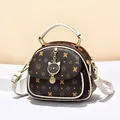 Deep brown cartoon print handbag with cream white handles and cat charm detail - Coffee and White