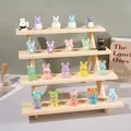 Detailed view of colorful cyberpunk animal figurines on a solid wood tiered display stand - 4 Tiers