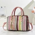 Rainbow striped woven tote bag with pink leather handles and golden leaf charm - Pink