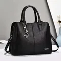 Classic black pebbled leather tote with silver ballerina charm and adjustable strap - Black